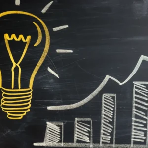 Chalk drawing of light bulb with rising bar graphs.