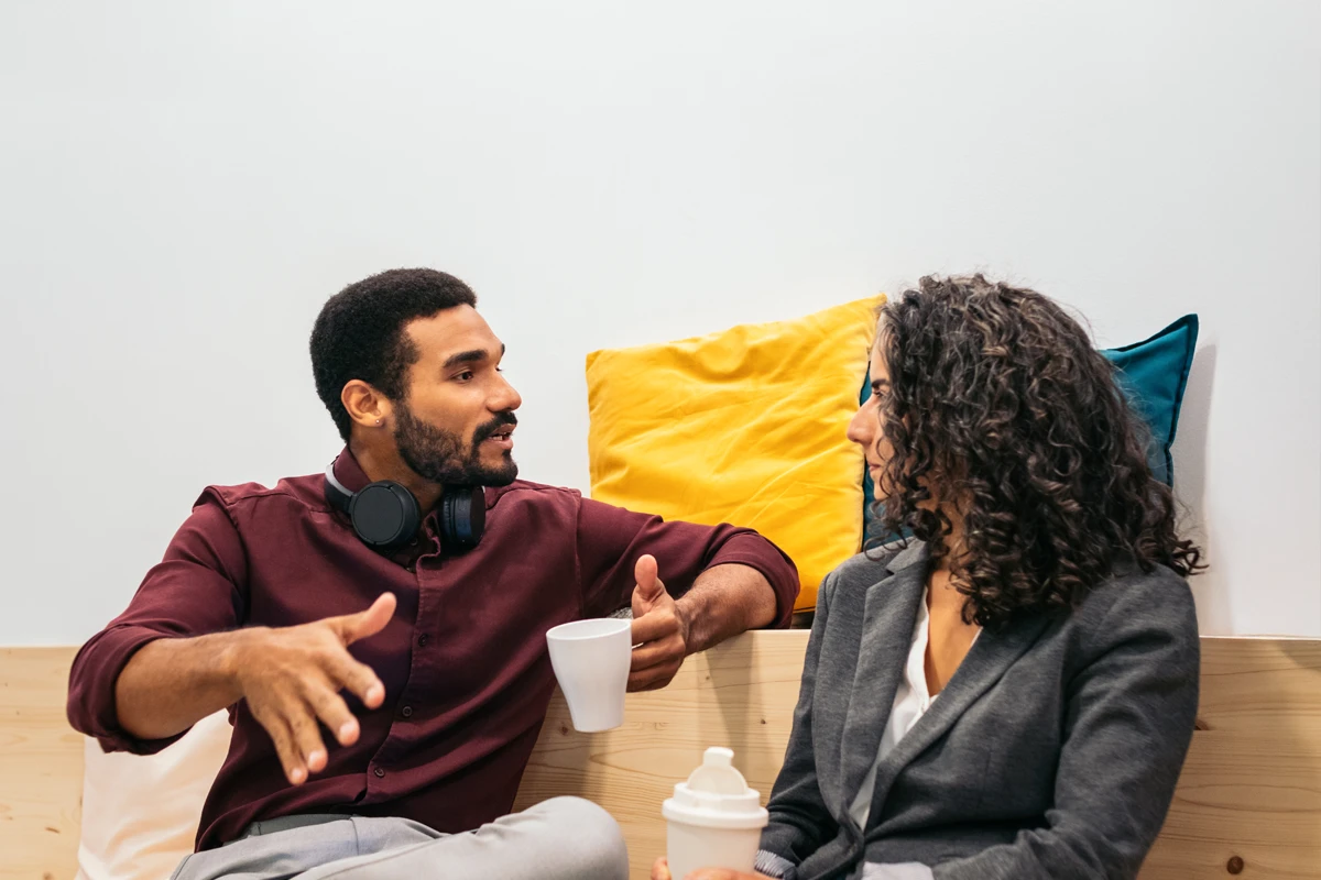 Couple engaging in a lively conversation in living room.