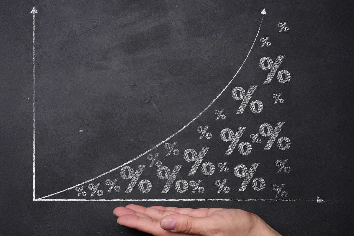 Hand under chalk growth chart with increasing percentages