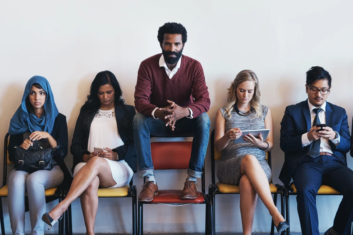 Diverse group of people sitting in a waiting room