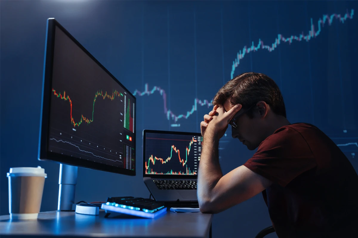 Distressed trader analyzing stock market crash