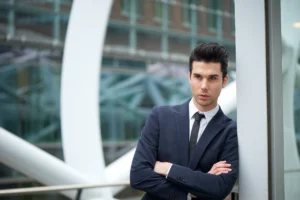 Confident businessman in suit outdoors with modern architecture