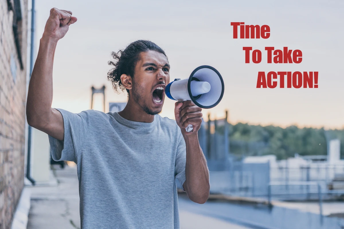 Man raising fist, yelling through megaphone