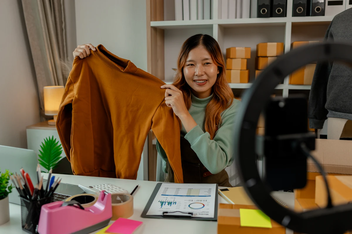 Fashion blogger showcasing mustard sweater during video stream