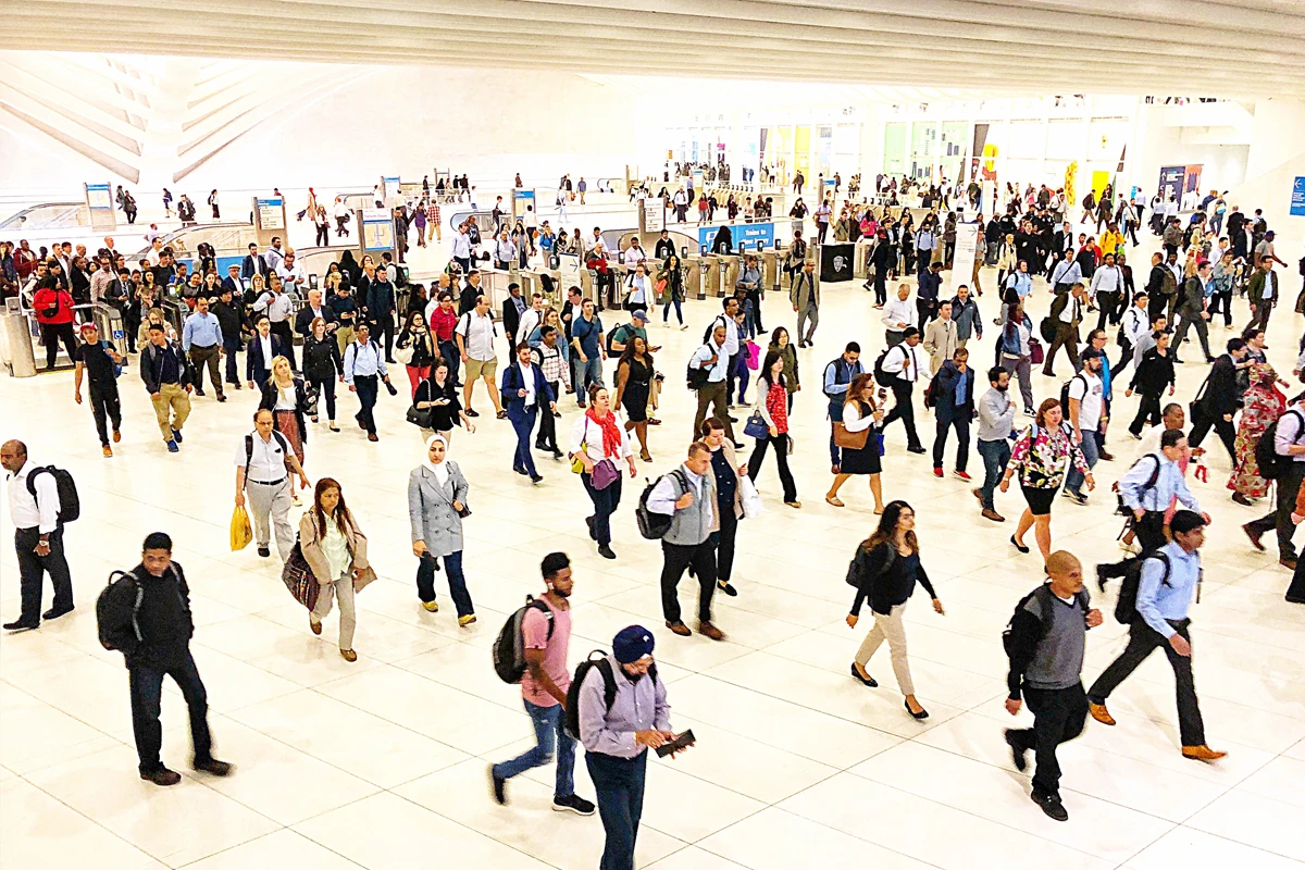 Busy train station with diverse crowd walking