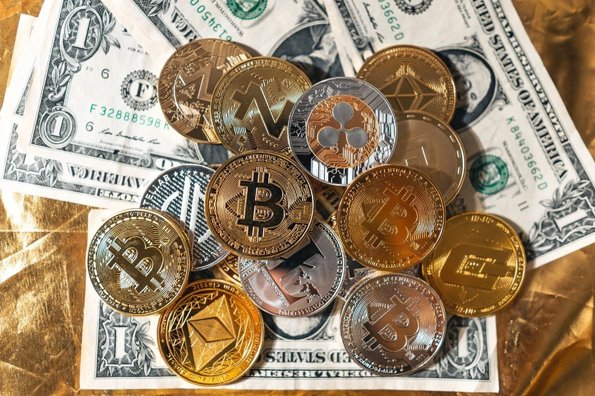 Assorted cryptocurrency coins on US dollar bills