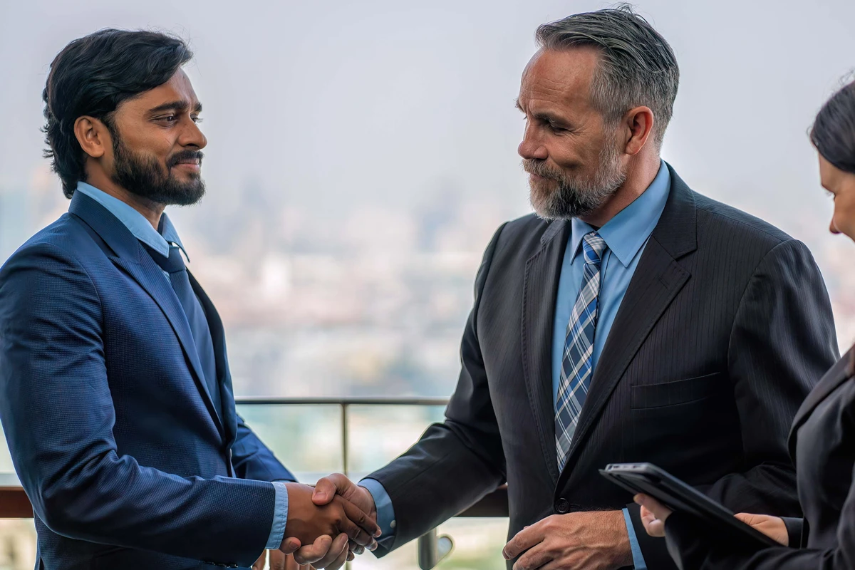 Businessmen shaking hands with cityscape in background