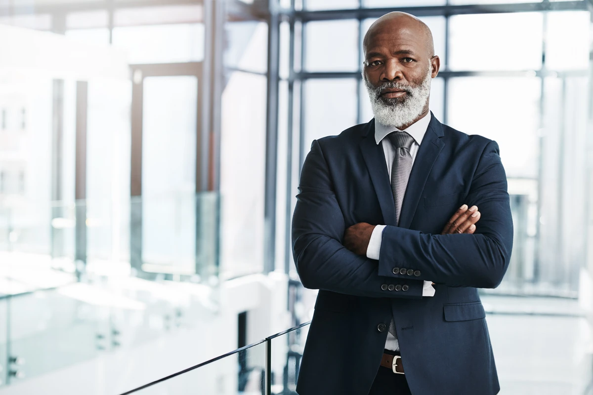 Confident businessman standing in modern office