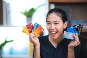 Happy woman holding multiple credit cards