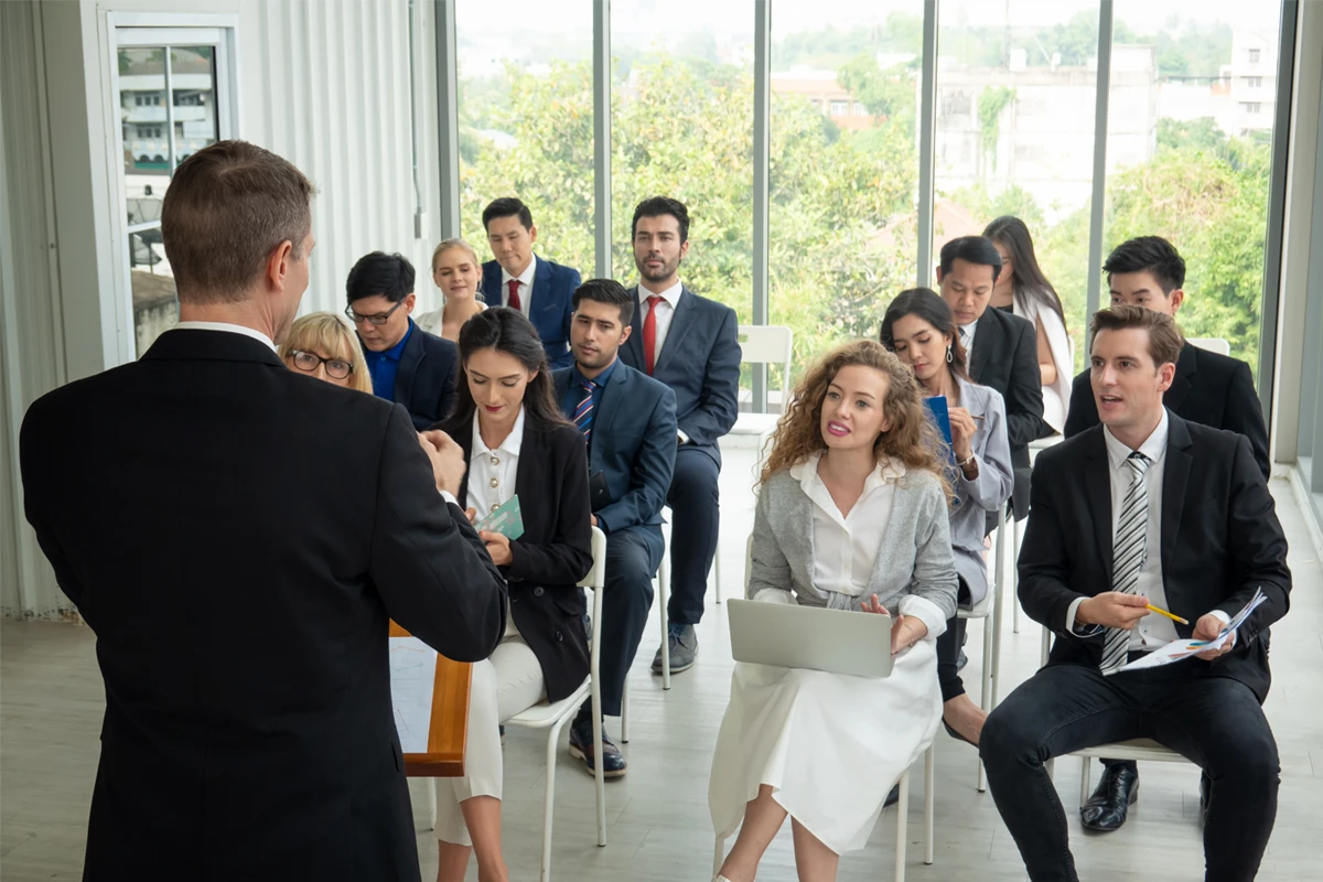 Business meeting with diverse group attentive to speaker