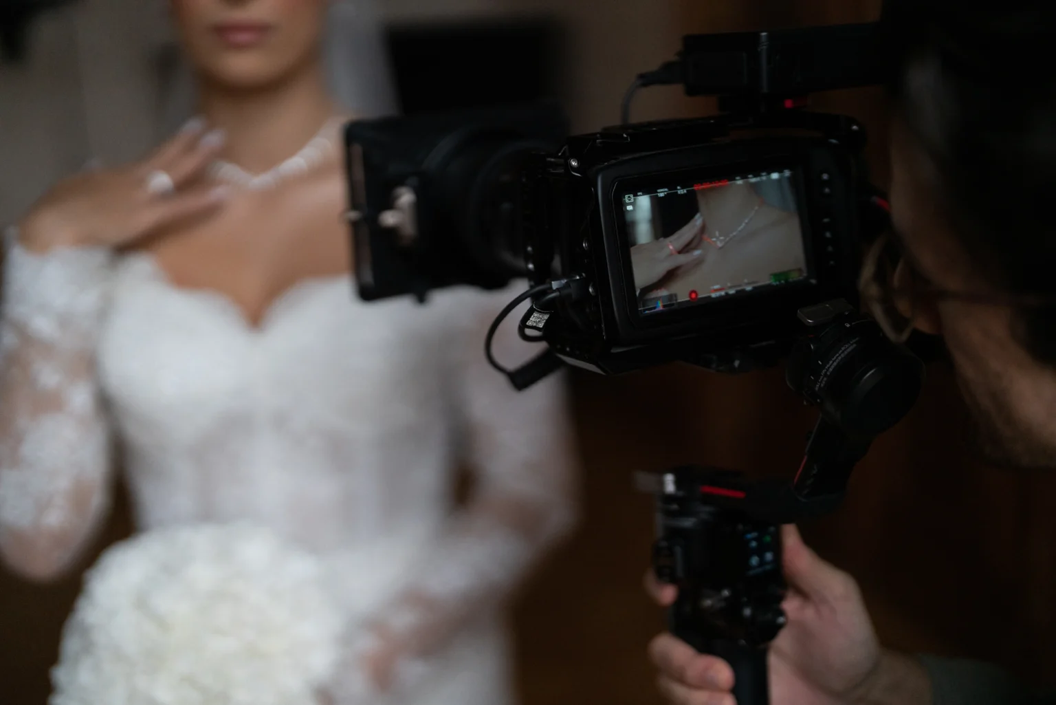 Videographer recording bride in elegant dress