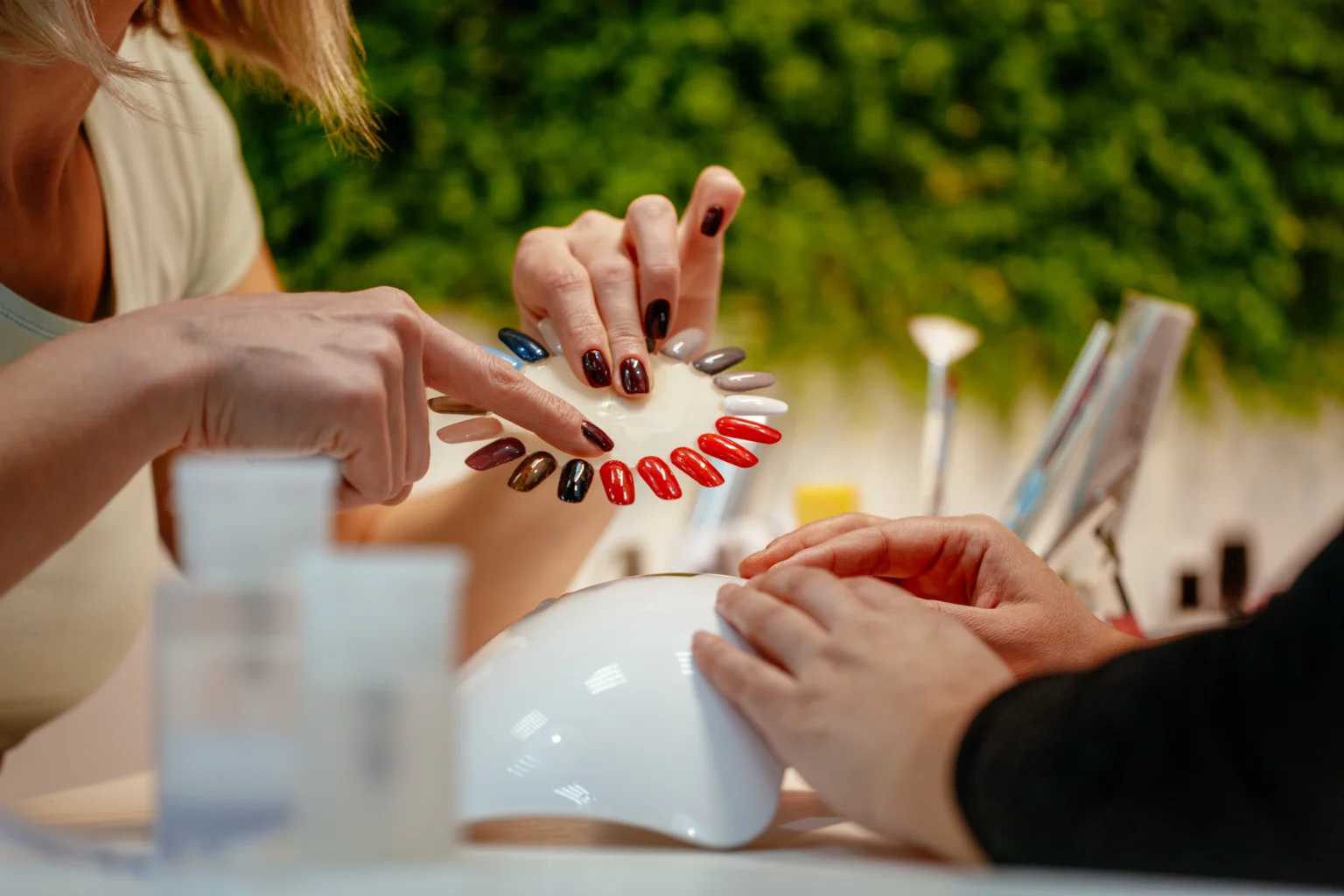 Client choosing nail polish colors at salon
