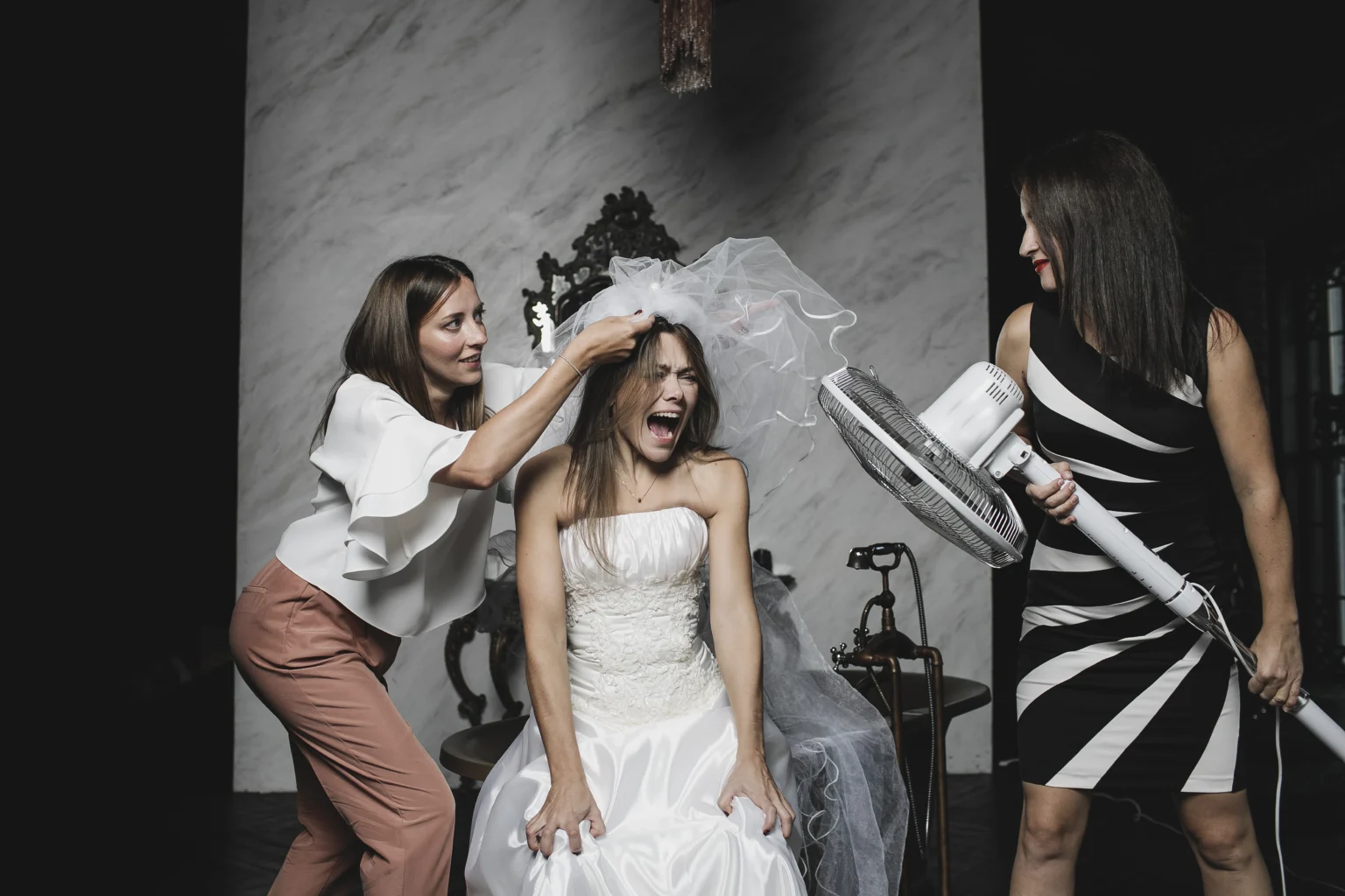 Bride laughing as friends style with whimsical tools