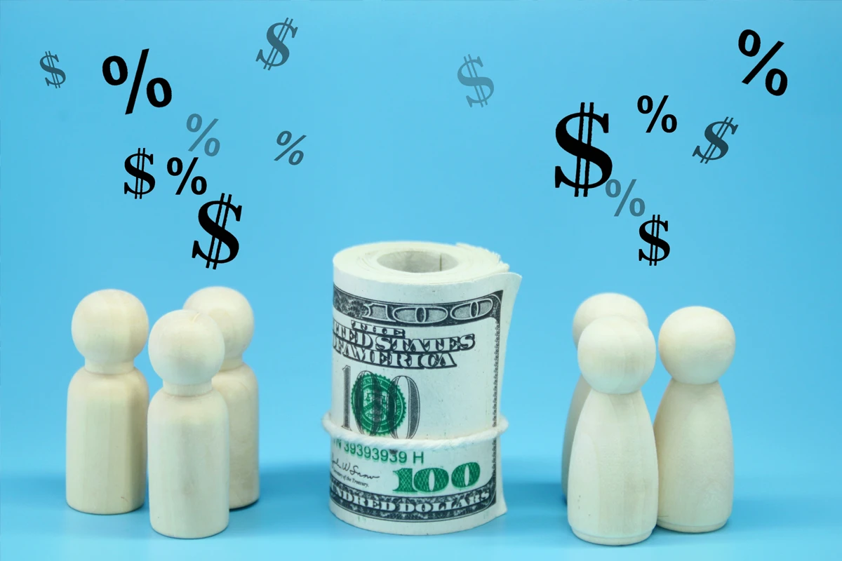 Wooden figures contemplating toilet-paper-roll cash concept
