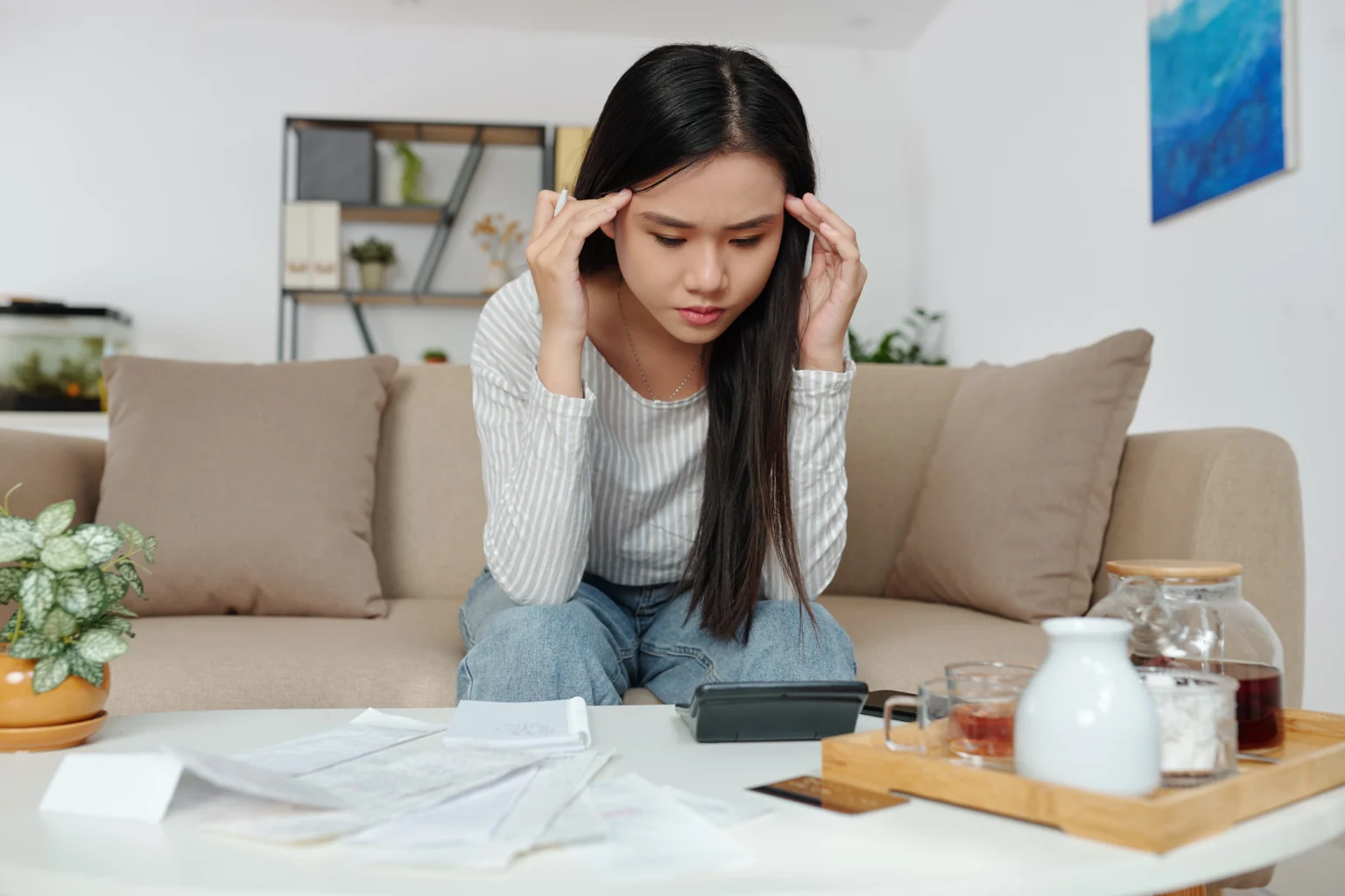 Stressed woman managing finances at home