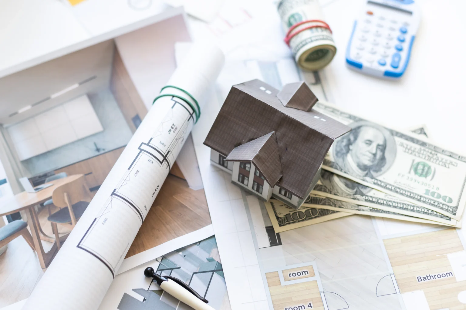 Home renovation blueprint, model house, and finances