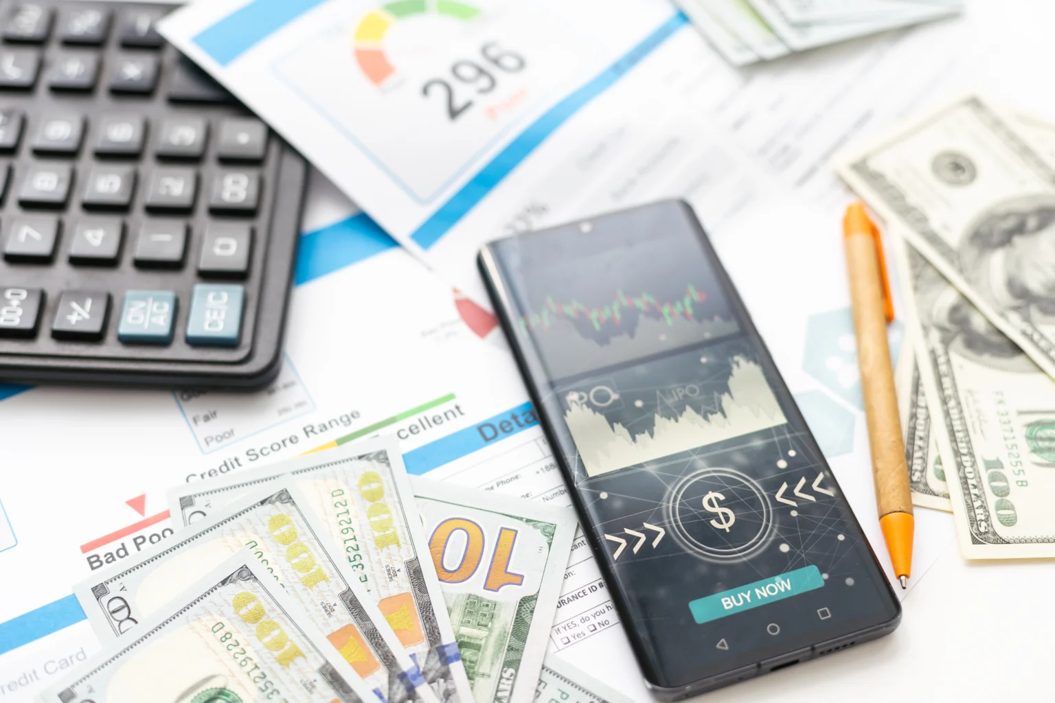 Smartphone with finance app among financial documents, cash