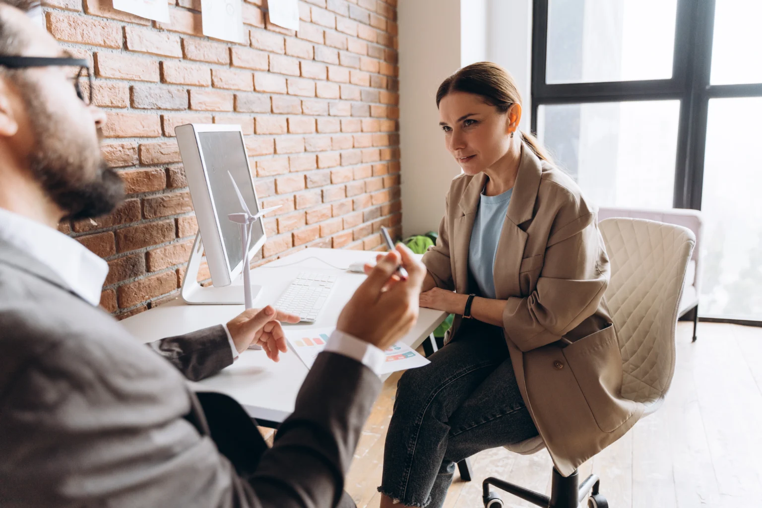 Business meeting in modern brick office space