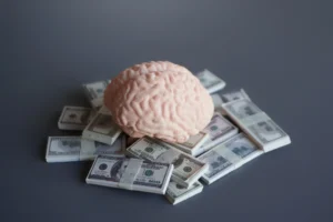 Human brain model on stacks of US dollar bills