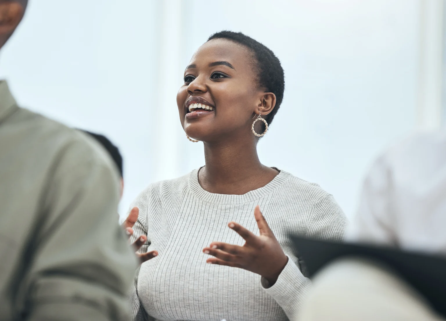 Joyful woman explaining ideas in a meeting