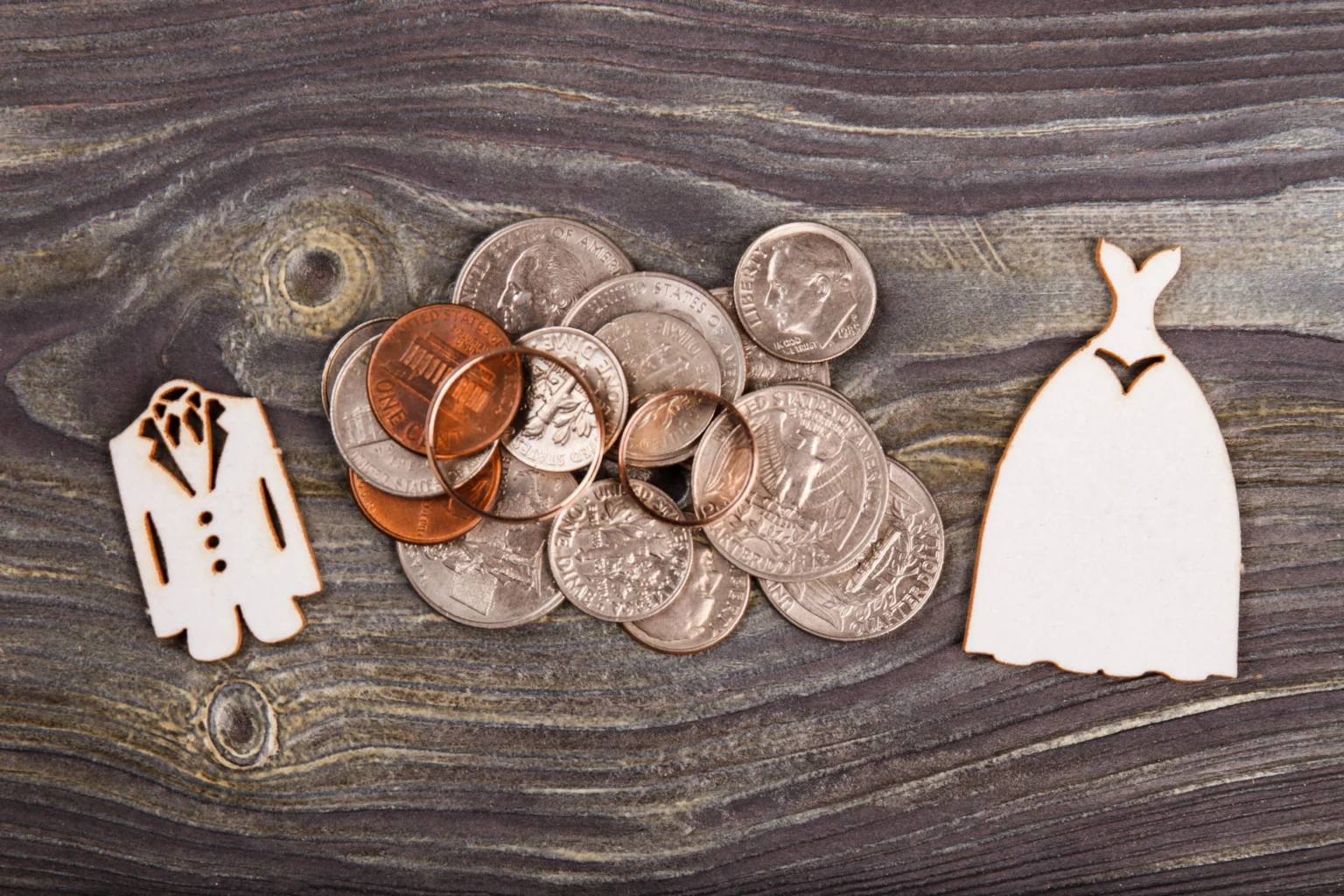 Wedding expense concept with coins and symbolic outfits