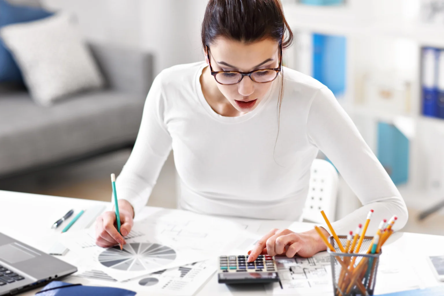Designer calculating colors for project at desk