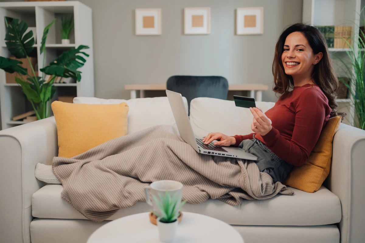 Smiling woman shopping online with credit card