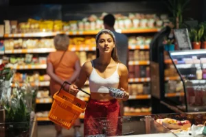 Woman shopping for groceries in a supermarket aisle