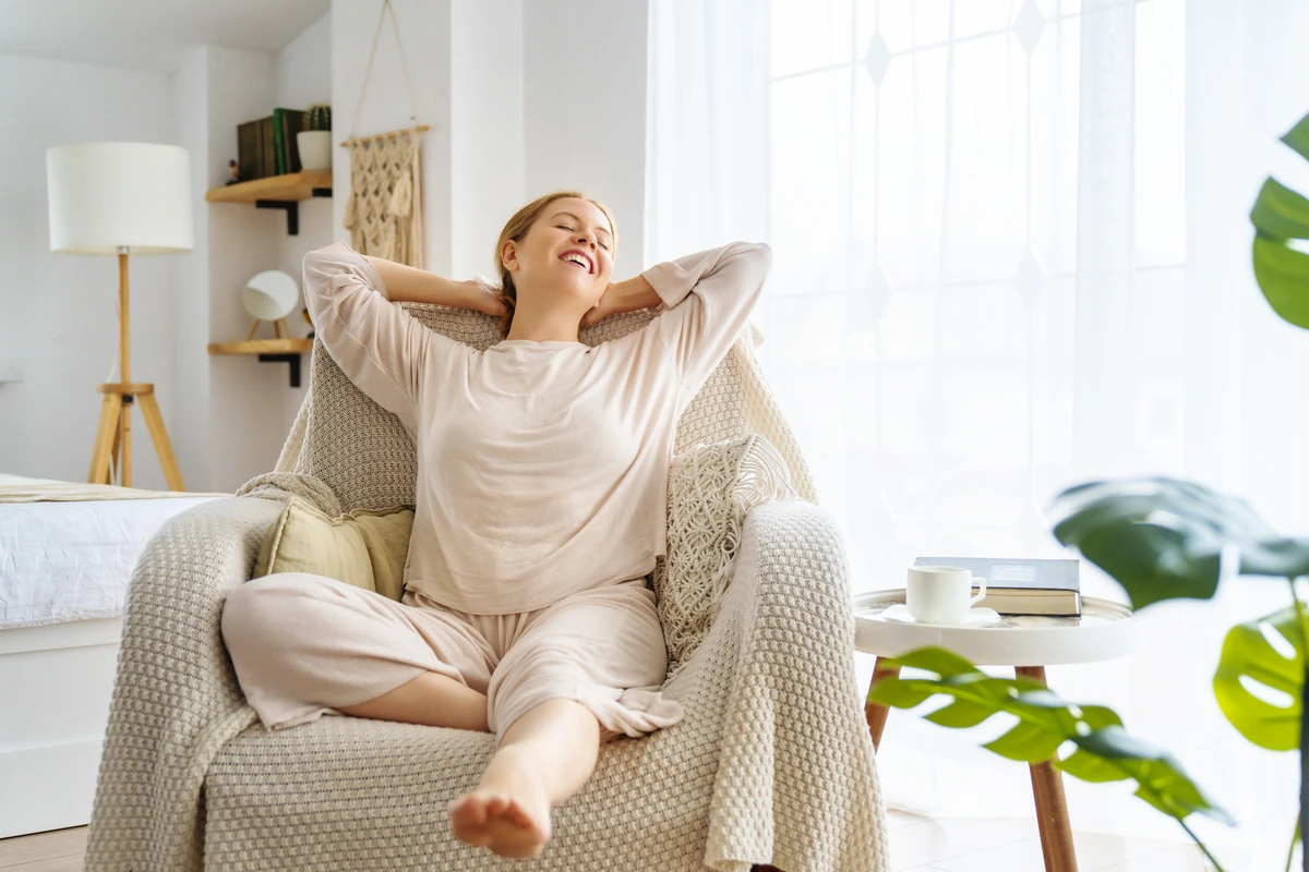 Woman relaxing in cozy living room chair