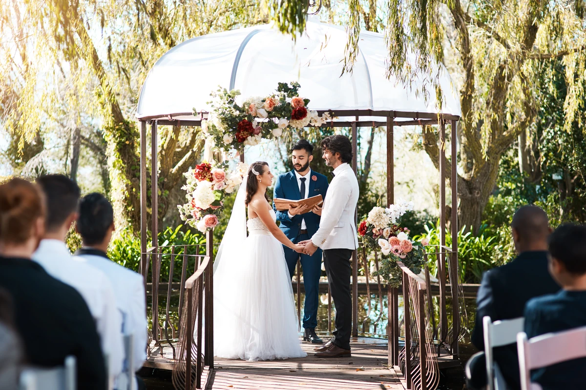 Outdoor wedding ceremony with couple exchanging vows