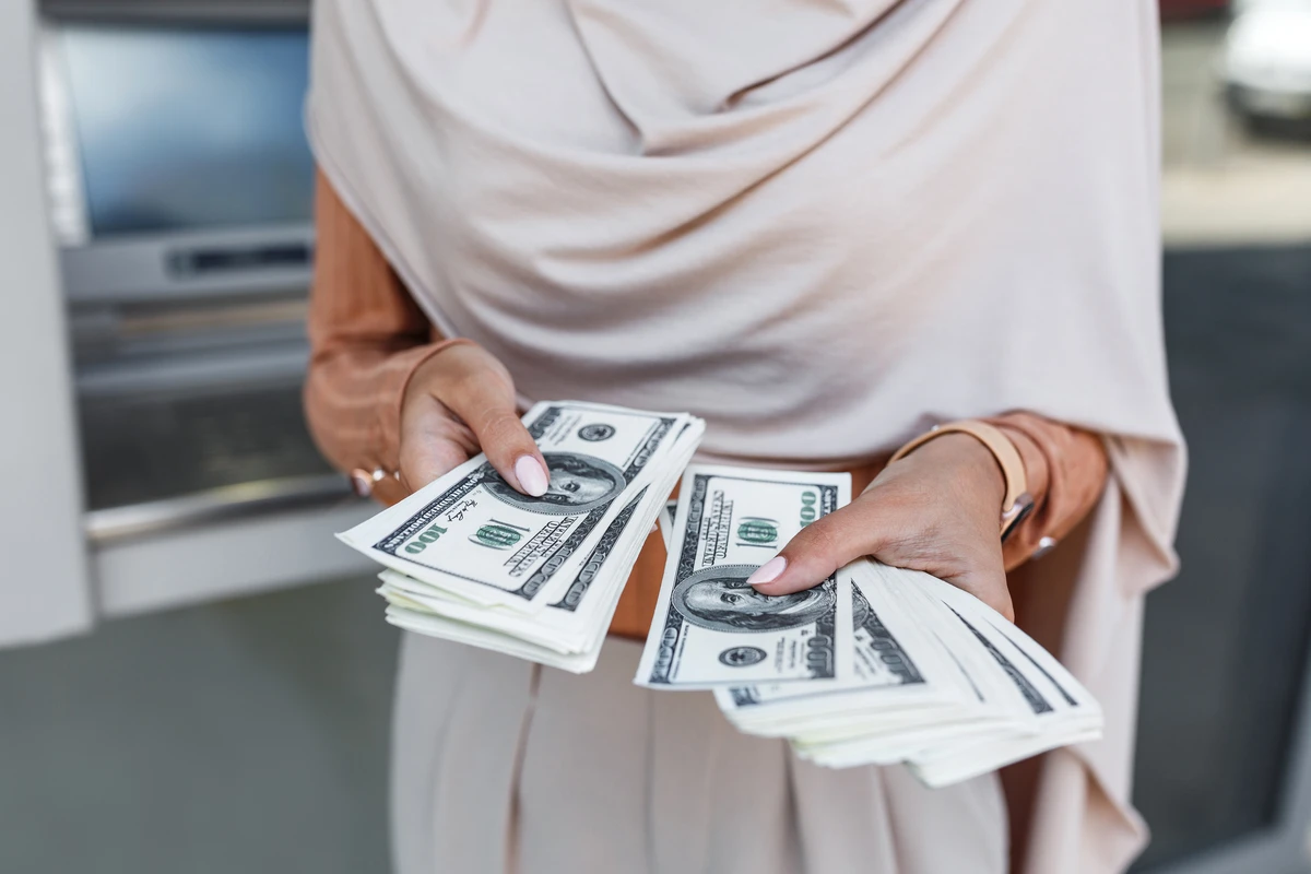 a woman holding money in her hands